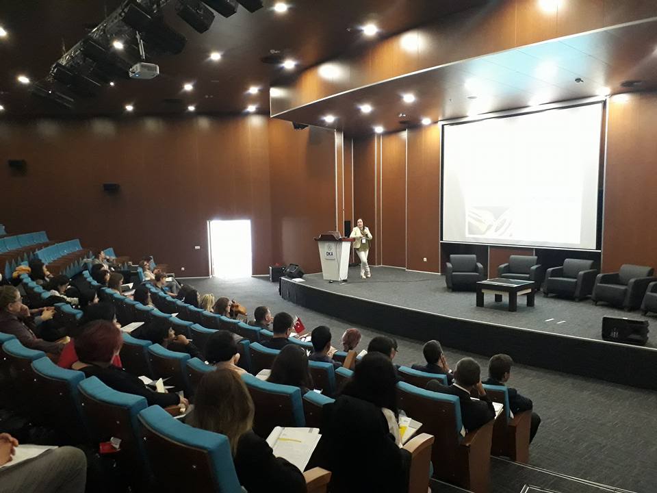 A conference session in a full auditorium